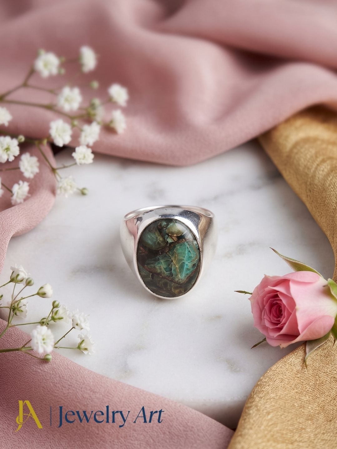 Handcrafted Copper Chrysocola gemstone ring for men in silver plated GS displayed in a luxury decorative jewelry setup with elegant props, highlighting the natural gemstone and artisan craftsmanship.
