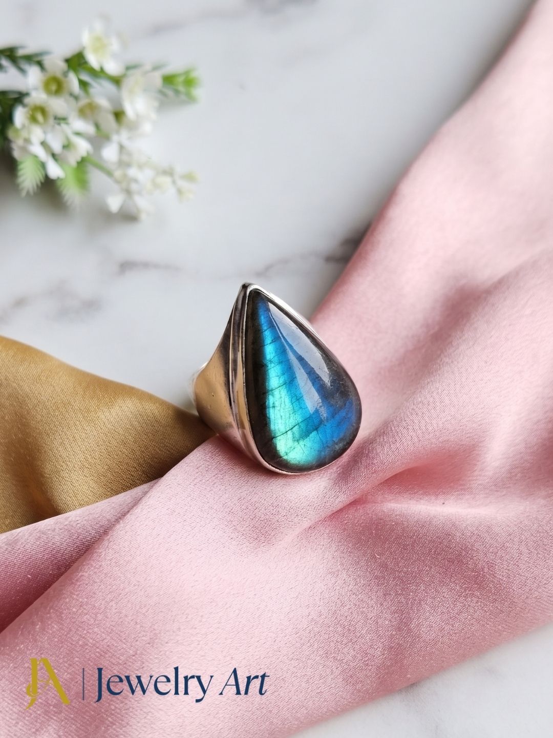 Designer natural Labradorite gemstone silver plated GS ring showcased in a sophisticated decorative jewelry display highlighting artisan craftsmanship.
