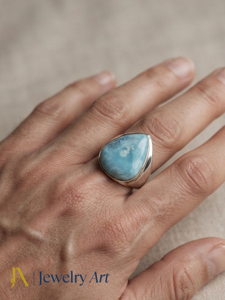 Male model wearing a handcrafted natural Larimar gemstone Silver Overlay GS bold statement ring, showcasing premium artisan craftsmanship with modern men's fashion styling.
