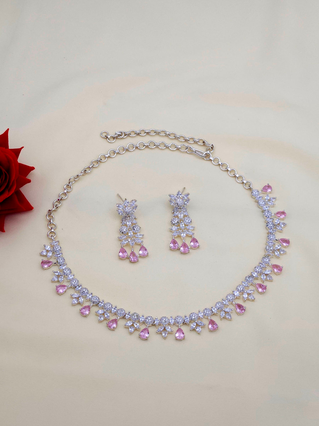 Glamorous rhodium plated CZ and pink hydro quartz necklace and earring set for party or festive wear
