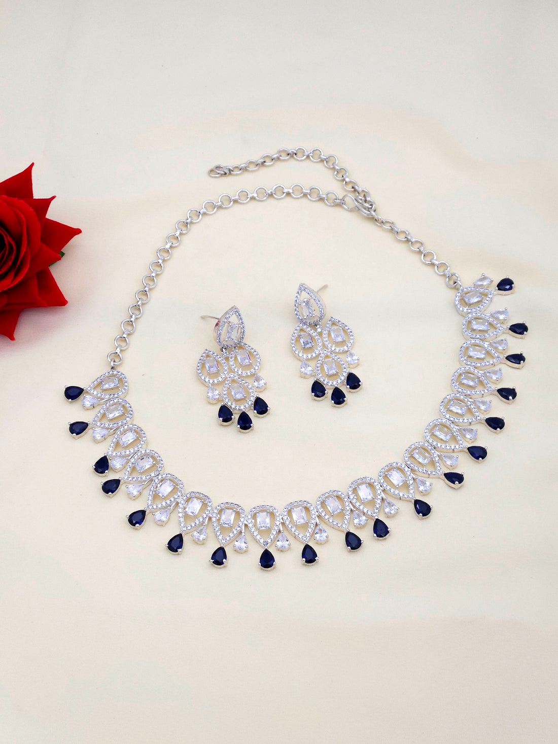 Stylish rhodium plated CZ necklace earring set with striking blue hydro quartz stones in designer finish
