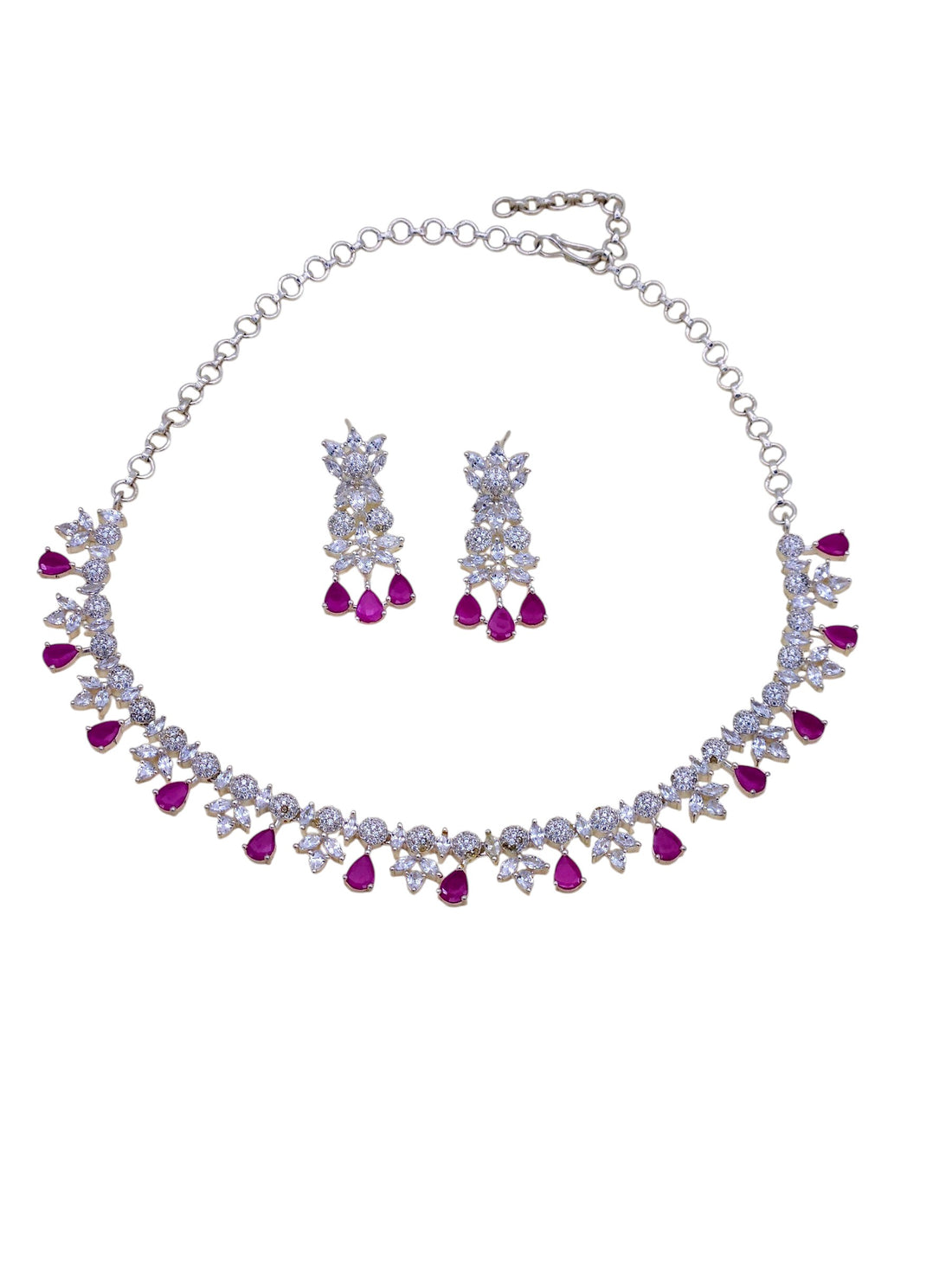 Designer silver jewelry set with rhodium plating, red beryl stones, and CZ accents – necklace and matching earrings
