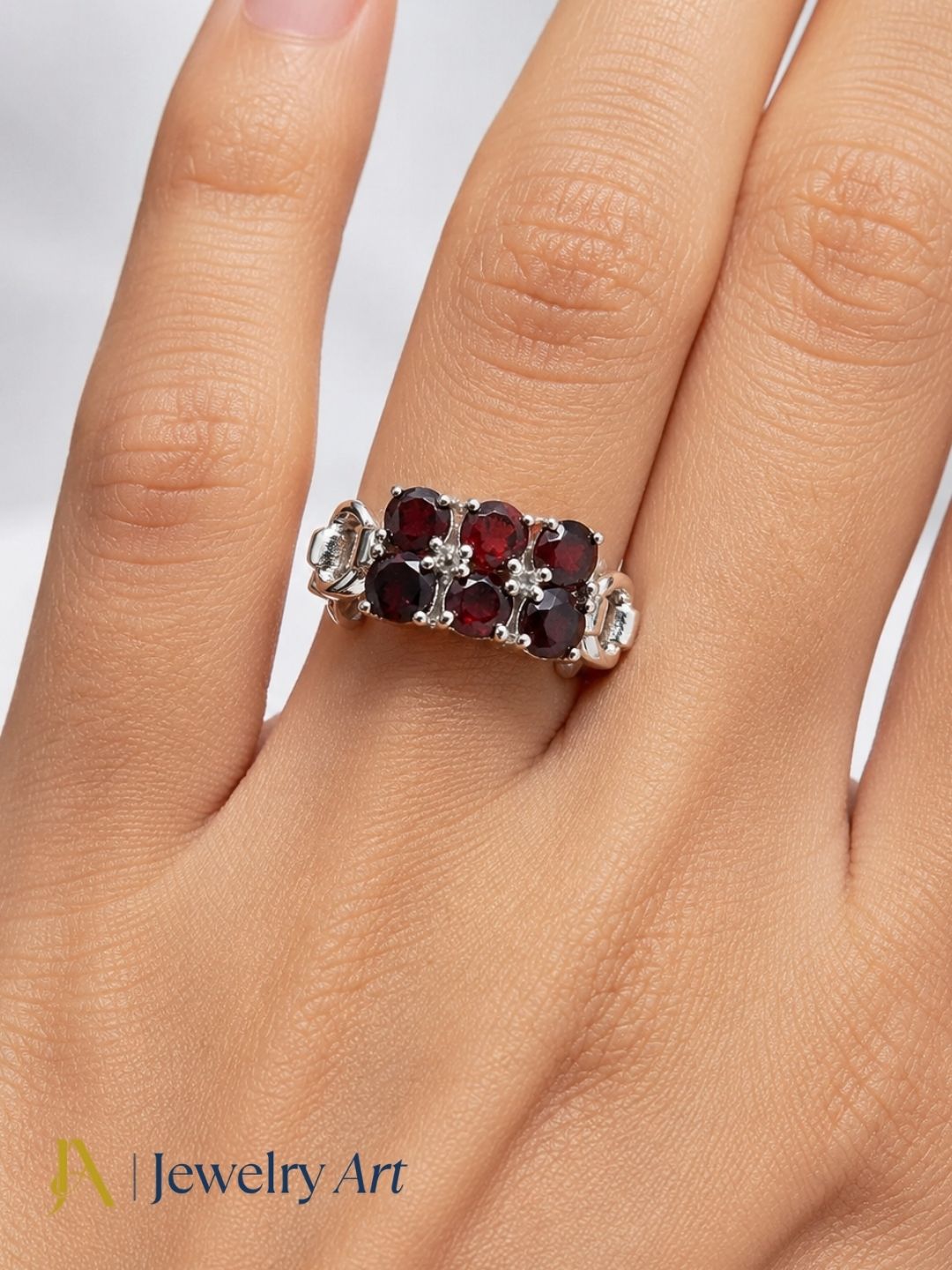 Model wearing artisan 925 sterling silver Garnet gemstone ring