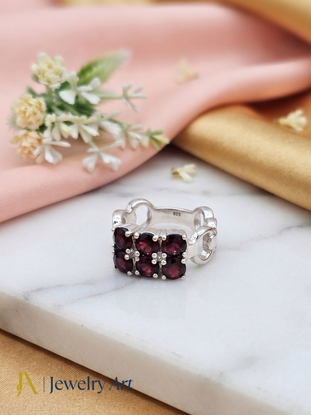 Elegant Garnet sterling silver ring in premium jewelry display
