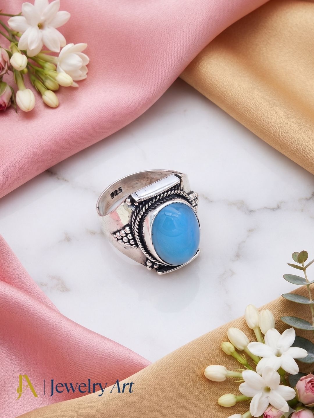 Designer Blue Chalcedony sterling silver ring with elegant decorative props

