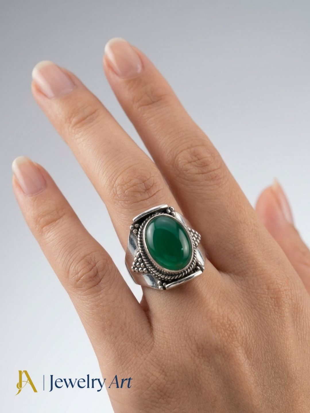Close-up of hand wearing handcrafted Green Onyx silver ring
