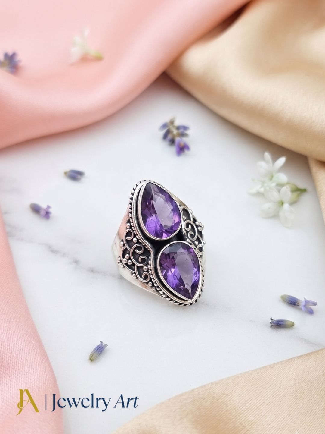 Artistic flat lay of handcrafted 925 oxidized silver Amethyst gemstone ring