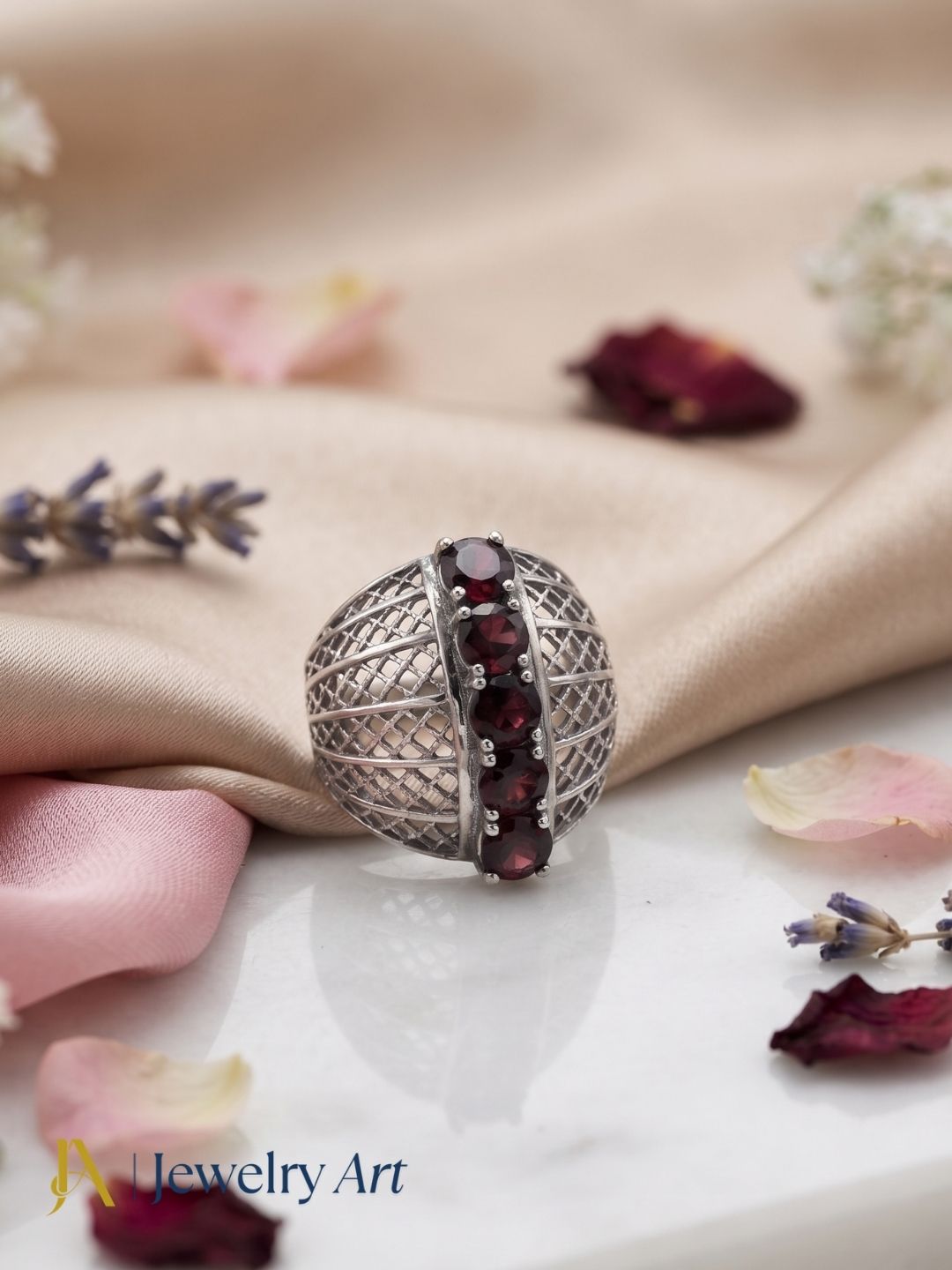 Artistic flat lay of handcrafted 925 oxidized silver Garnet gemstone ring